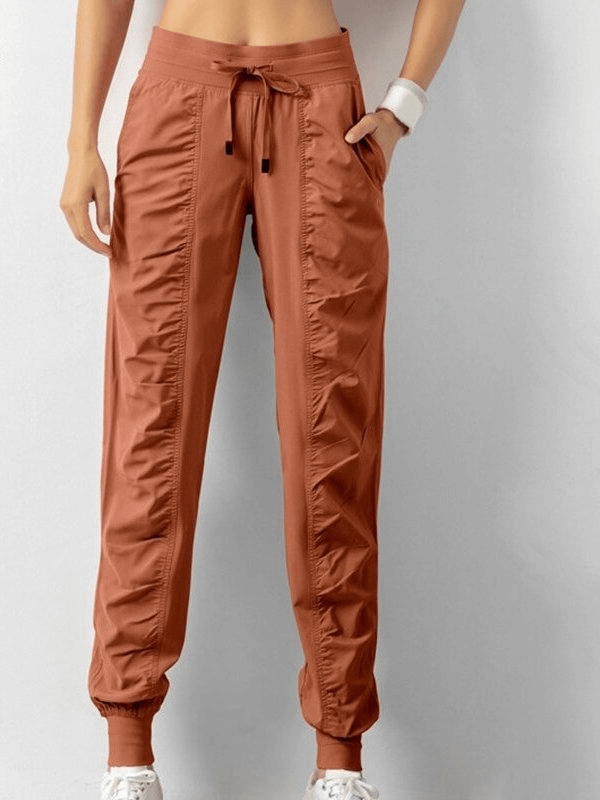 Women's Sports Joggers with Side Pockets and Cuffs in polyester, featuring a drawstring waist and loose fit for casual style.